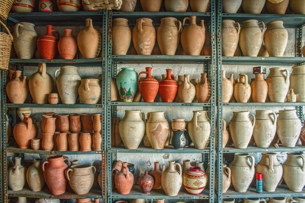 An image of a store filled with arts and crafts items like jugs, mugs and other sculptures.